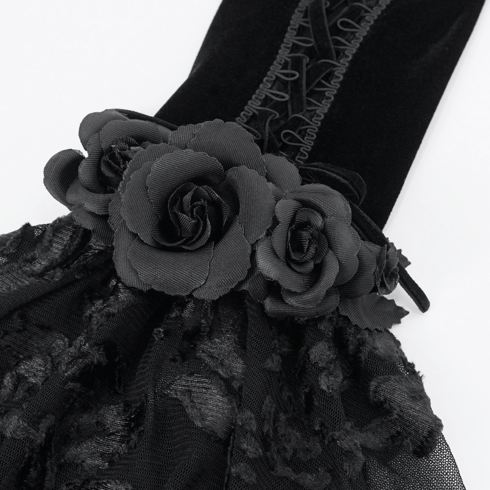 Close-up of Gothic black velvet and lace gloves with floral detail, perfect for elegant evening wear.