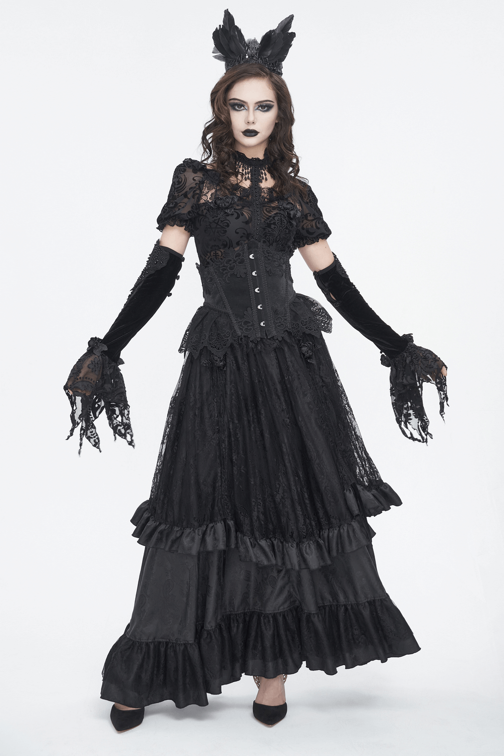 Elegant model in Gothic velvet and lace evening gloves paired with a dramatic black lace gown.
