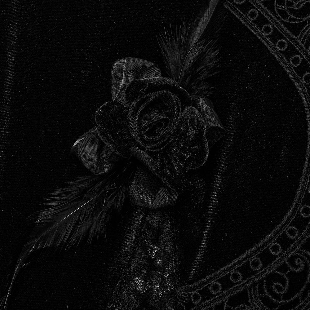 Close-up of black velvet rose with feather details on Gothic velvet lace pants, showcasing exquisite lace trim.