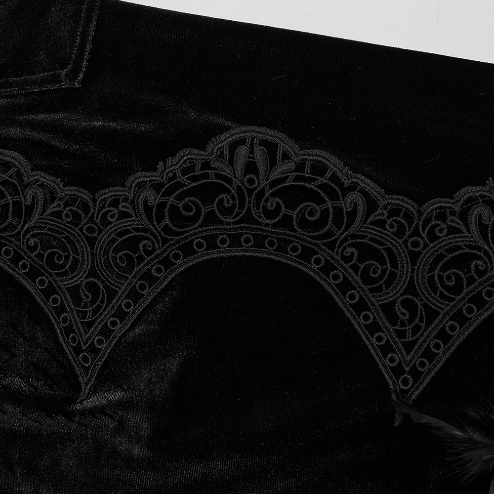 Close-up of luxurious black lace detailing on Gothic velvet pants with intricate floral patterns.
