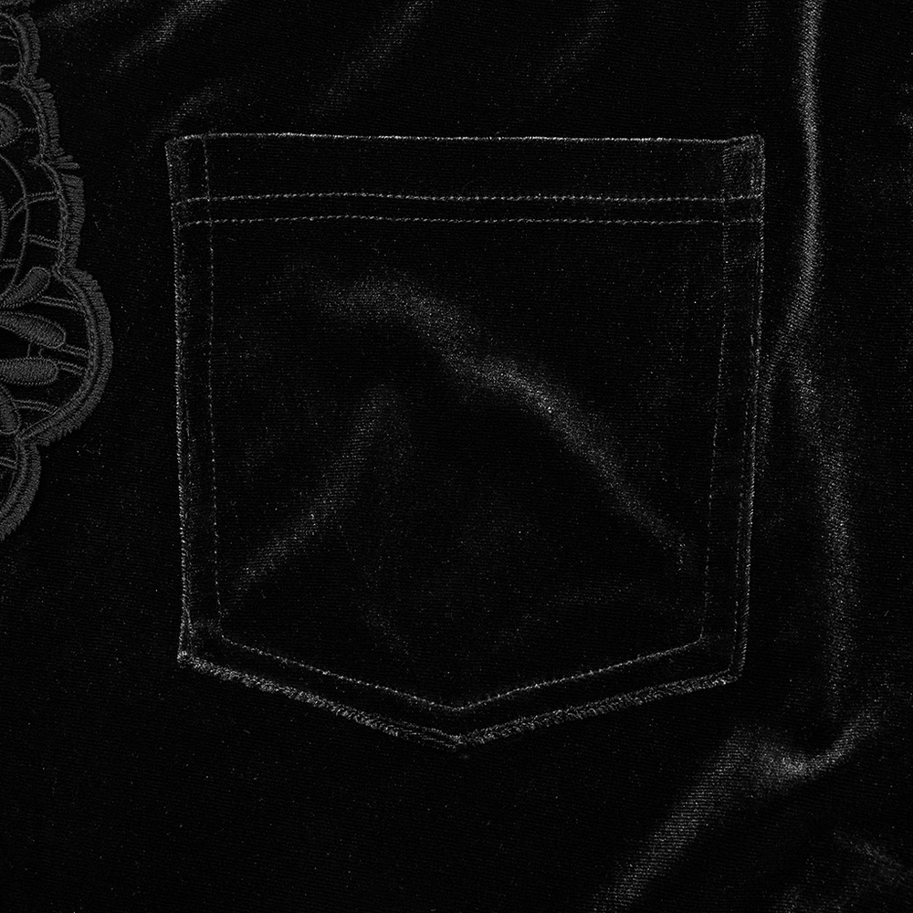 Detail of a patch pocket on luxurious black velvet pants with floral lace trim, showcasing gothic fashion elegance.