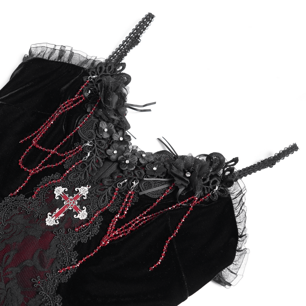 Gothic velvet and lace dress detail with beaded cross pendant and burgundy ruffles.