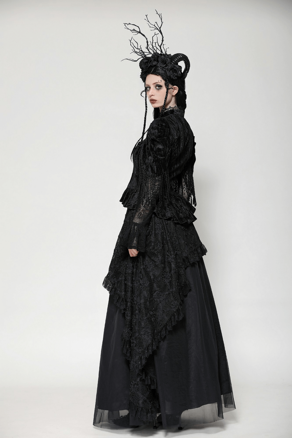 Gothic model showcasing a black velvet and lace corset top with flared sleeves and dramatic hairstyle. Perfect for Victorian-inspired fashion.