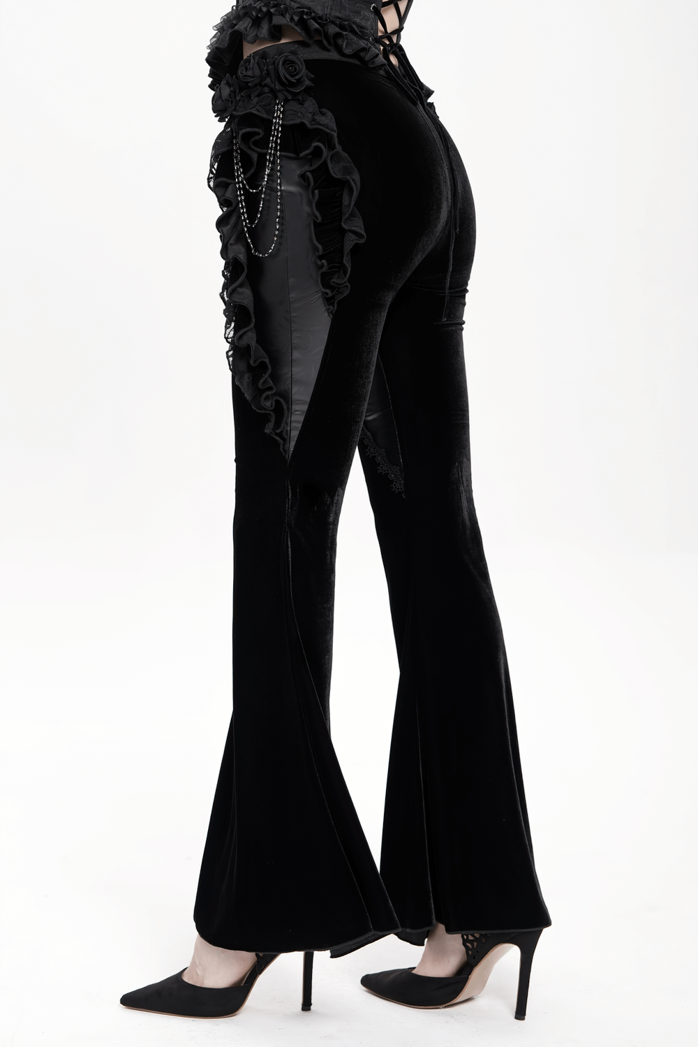 Gothic velvet and leather flare pants with lace ruffles and bead chains, showcasing a dramatic silhouette.