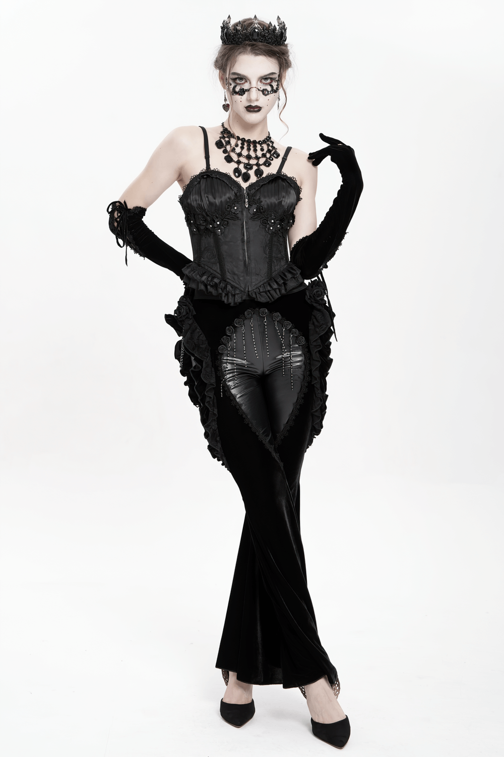 Model wearing Gothic velvet and leather flare pants with lace ruffles, striking a dramatic pose.