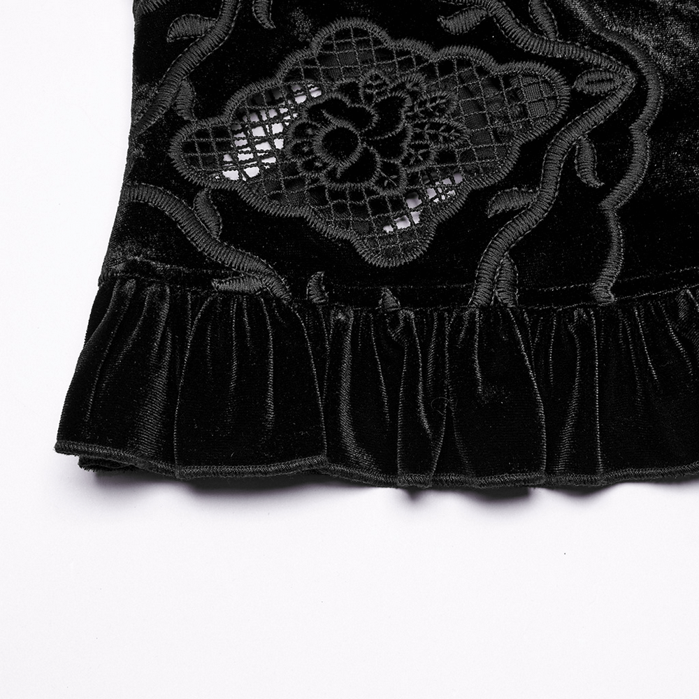 Close-up of gothic velvet blouse with intricate embroidery and ruffled hem, showcasing old-world elegance.