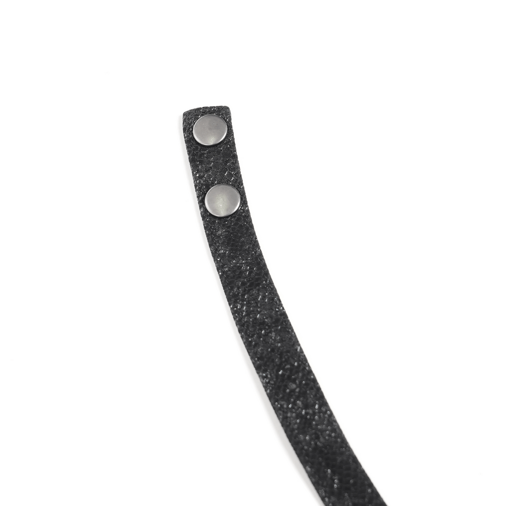 Close-up of a black faux leather strap with silver studs, perfect for adding edgy detail to gothic fashion.