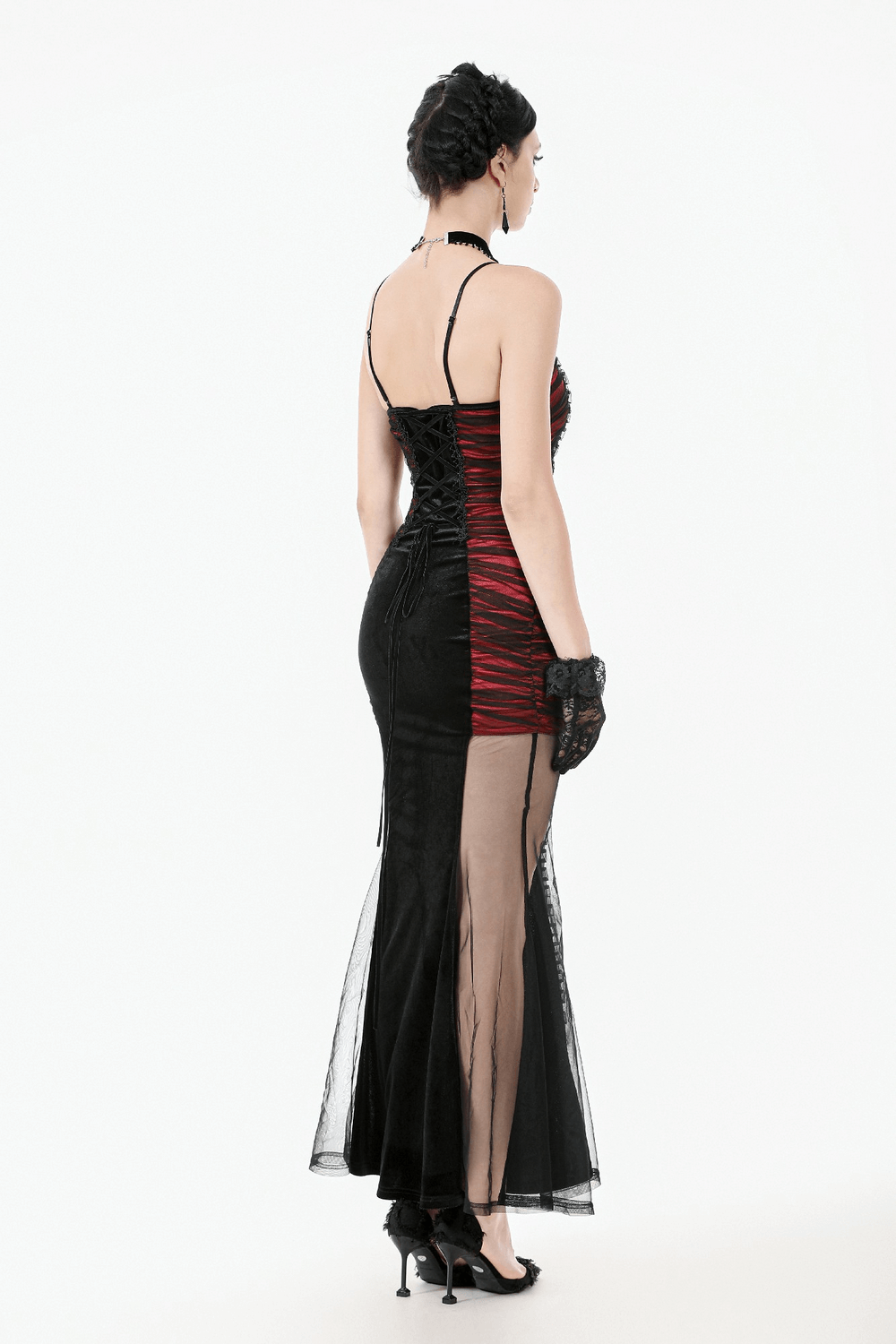 Elegant back view of a woman in a black and red gothic evening gown with lace gloves.
