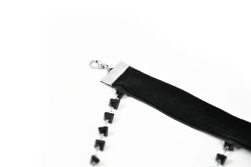 Close-up of a gothic velvet choker with black lace beads and a clasp, perfect for alternative fashion.
