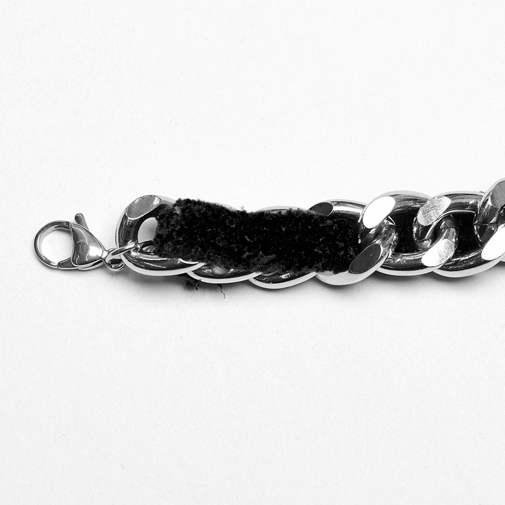 Close-up of a Gothic velvet choker with alloy chain, showcasing plush velvet and shiny metal links.