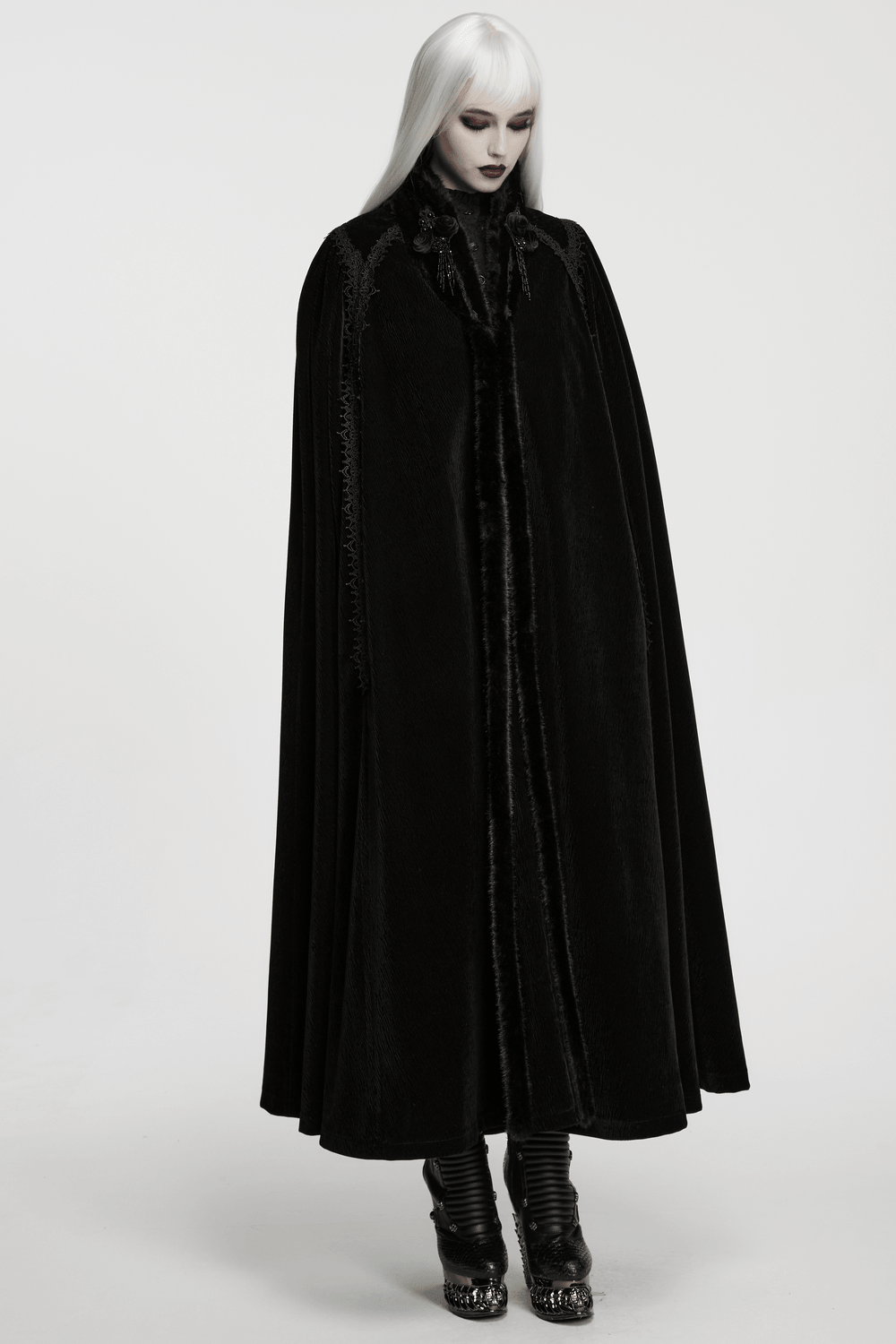 Gothic Velvet Cloak with Wool Collar and Lace Trim worn by model, showcasing its elegant black fabric and details.
