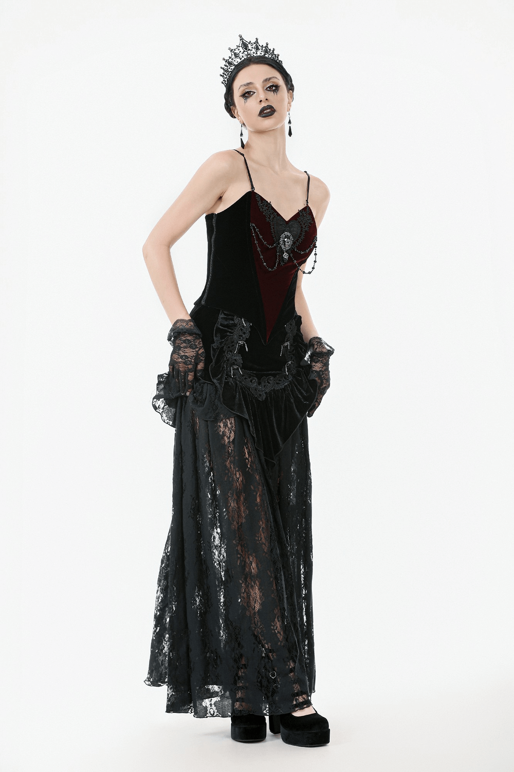Gothic velvet corset top with lace and chain details, paired with dramatic accessories and a striking look.