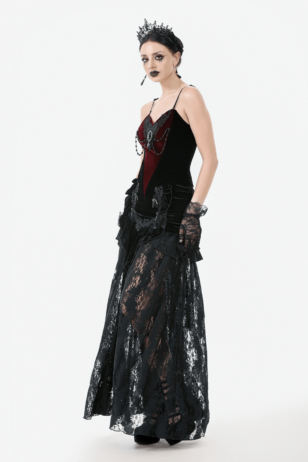 Gothic velvet corset top with lace accents, dramatic chains, and elegant black lace skirt for a stunning alternative fashion look.