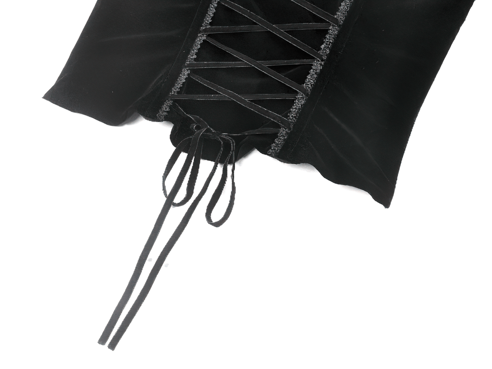 Close-up of lace-up back detailing on a black velvet corset top with intricate chain accents.