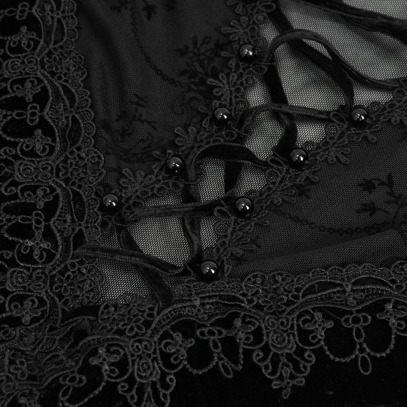 Close-up of black gothic velvet dress featuring lace, embroidery, and button details for an elegant touch.