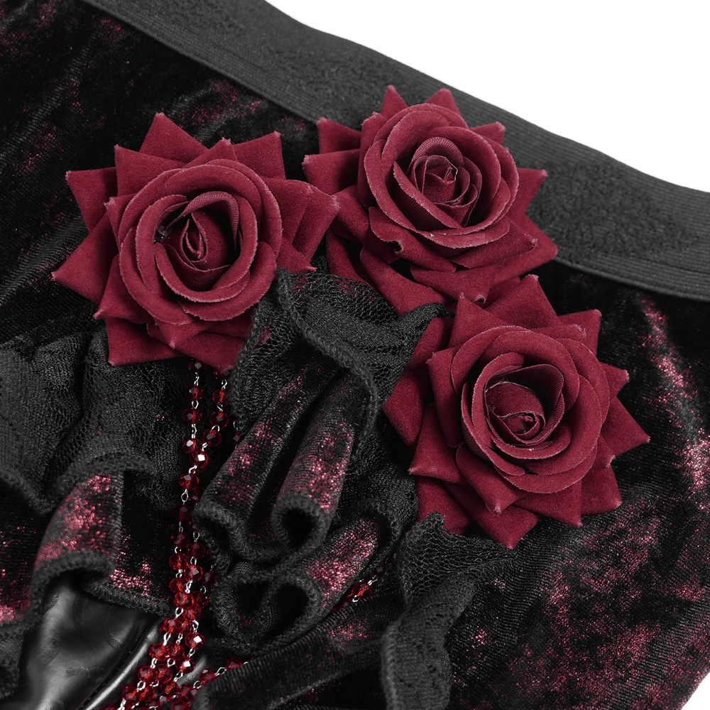 Gothic velvet flare pants with dark burgundy rose appliqués and cascading bead accents.