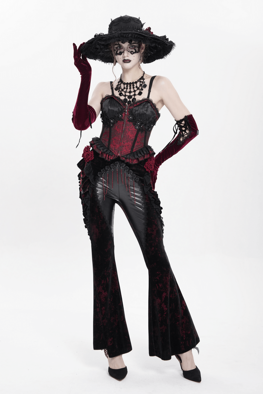 Gothic velvet flare pants with rose appliques, styled with a corset and dramatic accessories for dark romantic fashion.
