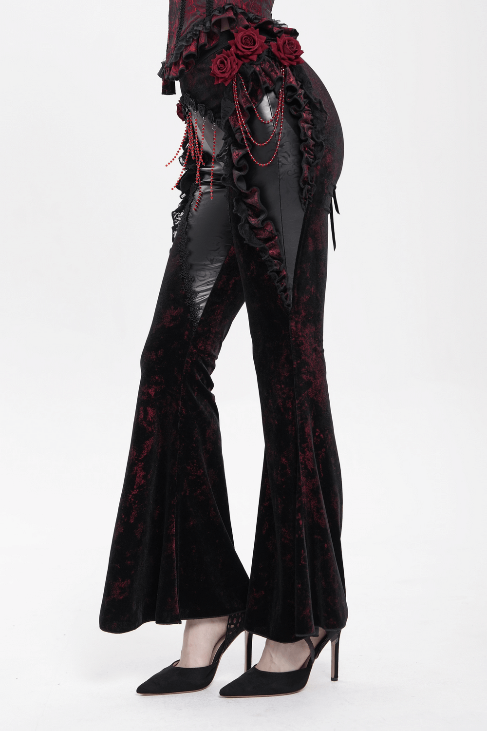 Gothic velvet flare pants with rose appliqués and leather details, perfect for dark romantic fashion lovers.