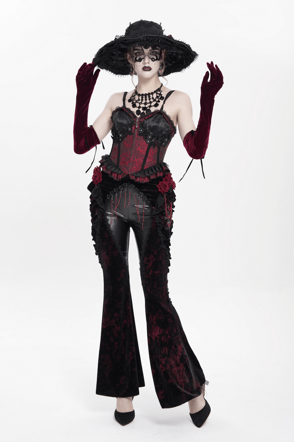 Gothic velvet flare pants paired with a dramatic corset and hat, showcasing dark romantic fashion with rose accents.