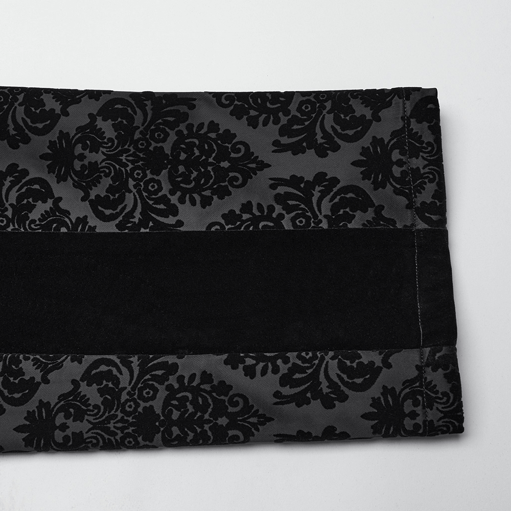 Close-up of Gothic velvet pant fabric featuring intricate floral flocking design and a smooth black band.