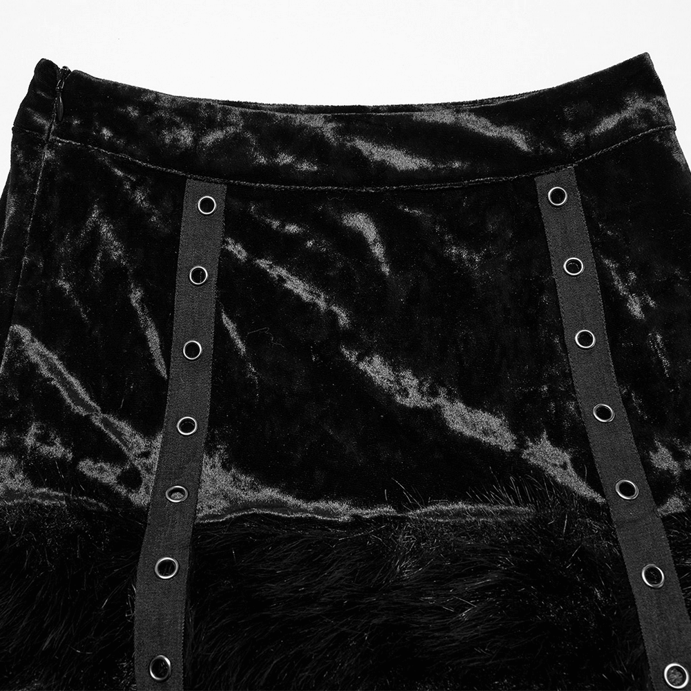 Close-up of a gothic velvet skirt with fur trim and edgy buckled straps for an alternative fashion look.