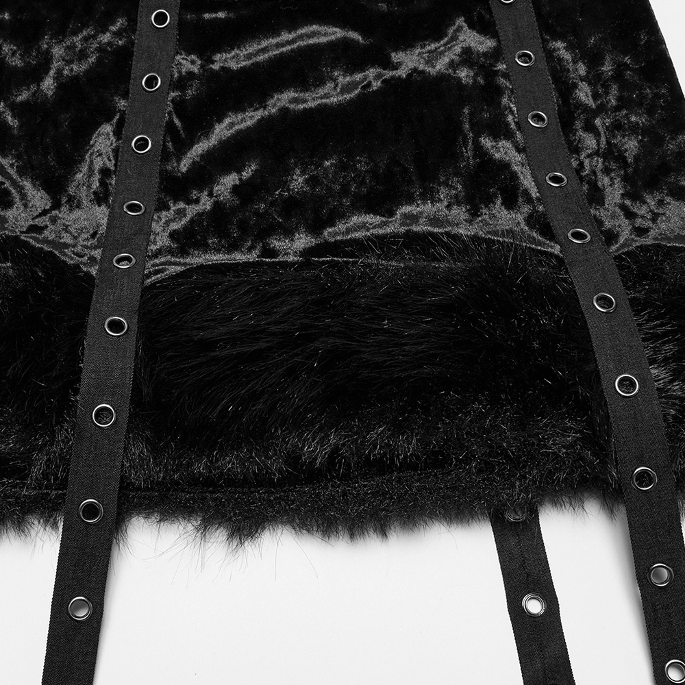 Close-up of gothic velvet skirt featuring fur trim and straps, showcasing edgy design details.