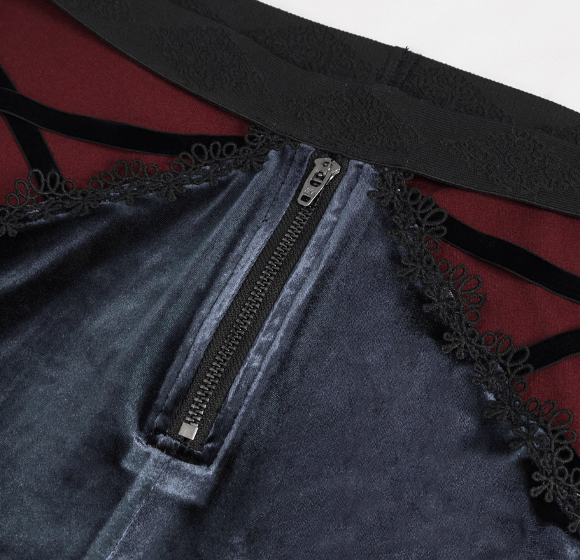 Close-up of gothic velvet flared trousers with lace trim and zipper detail, showcasing luxurious black fabric and elegant design.