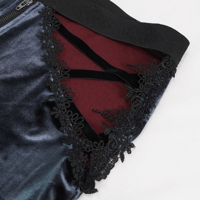 Close-up of gothic velvet flared trousers showing intricate lace applique and luxurious fabric detail.