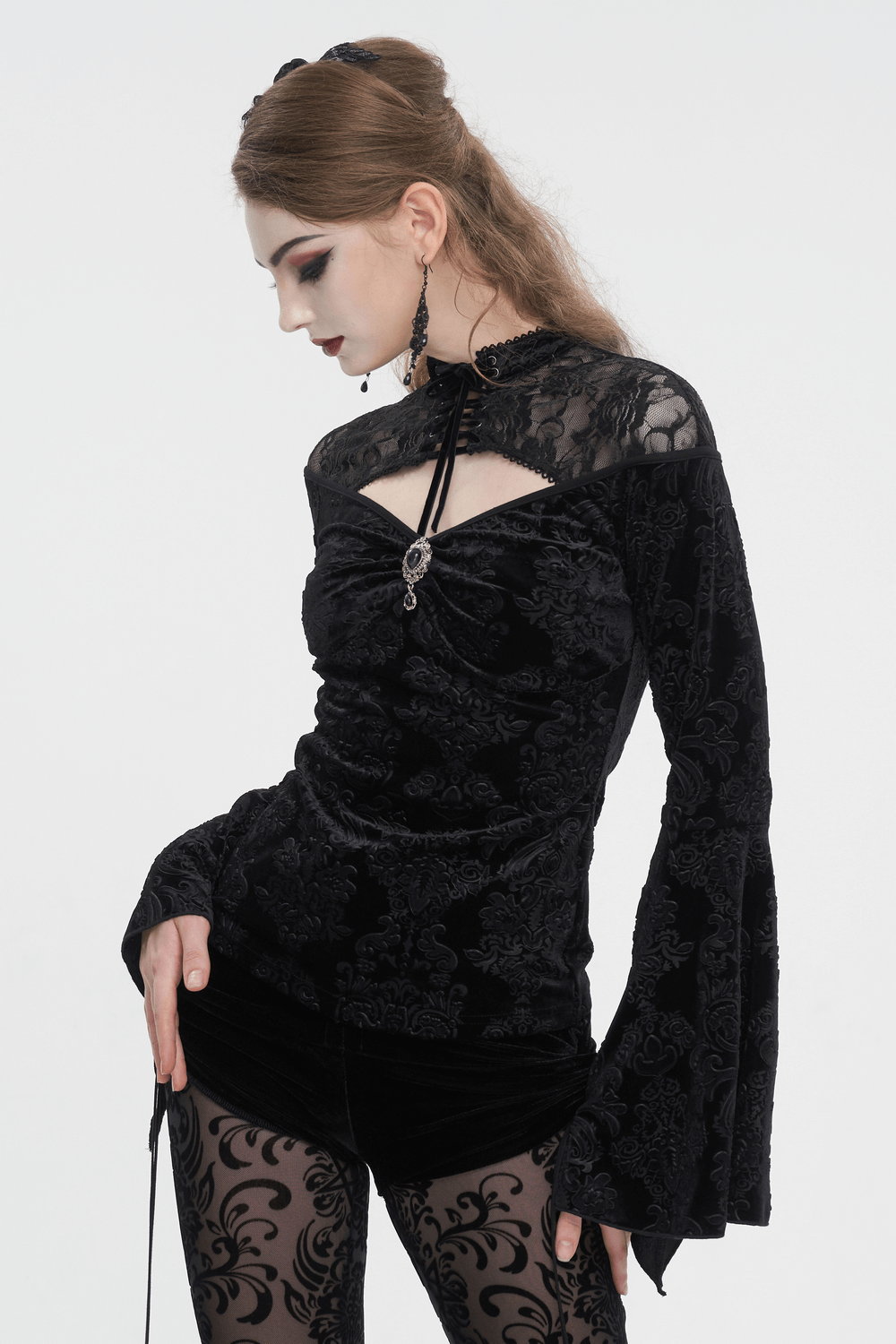 Gothic velvet hollow-out V-neck top with long bell sleeves, showcasing intricate designs in luxurious black fabric.