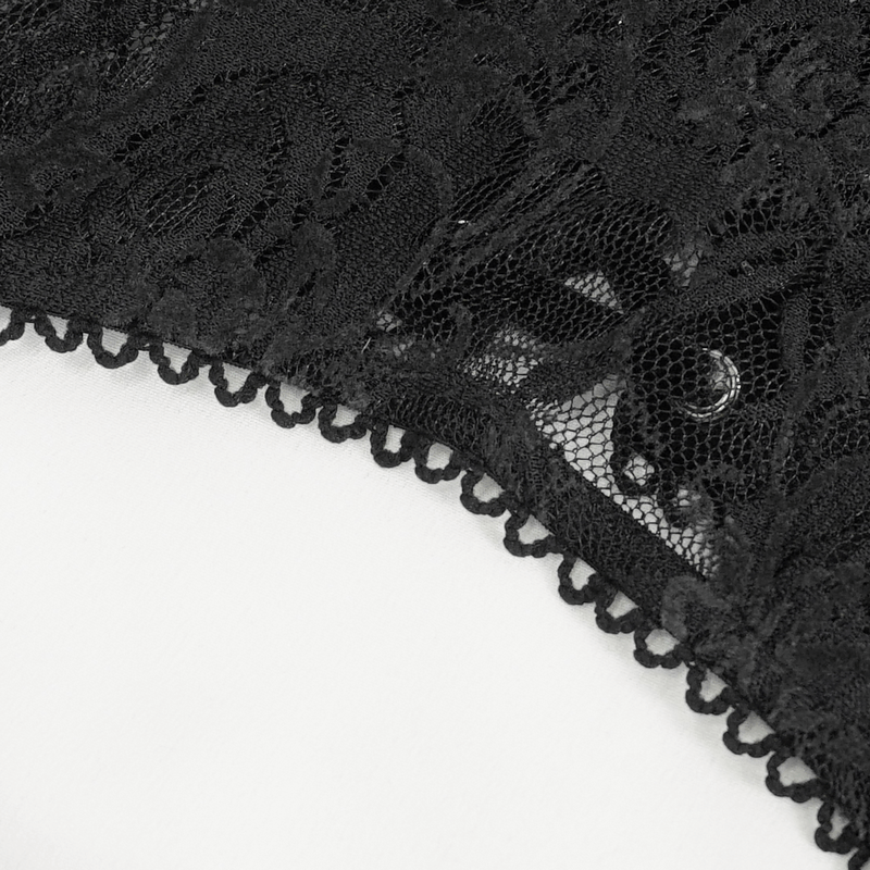 Close-up of intricate black lace with delicate embroidery, showcasing a gothic-inspired design detail.