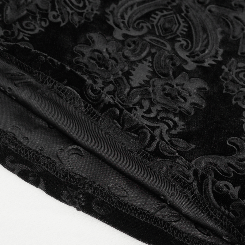 Close-up of luxurious gothic velvet fabric with intricate floral patterns and smooth finish, perfect for elegant clothing.