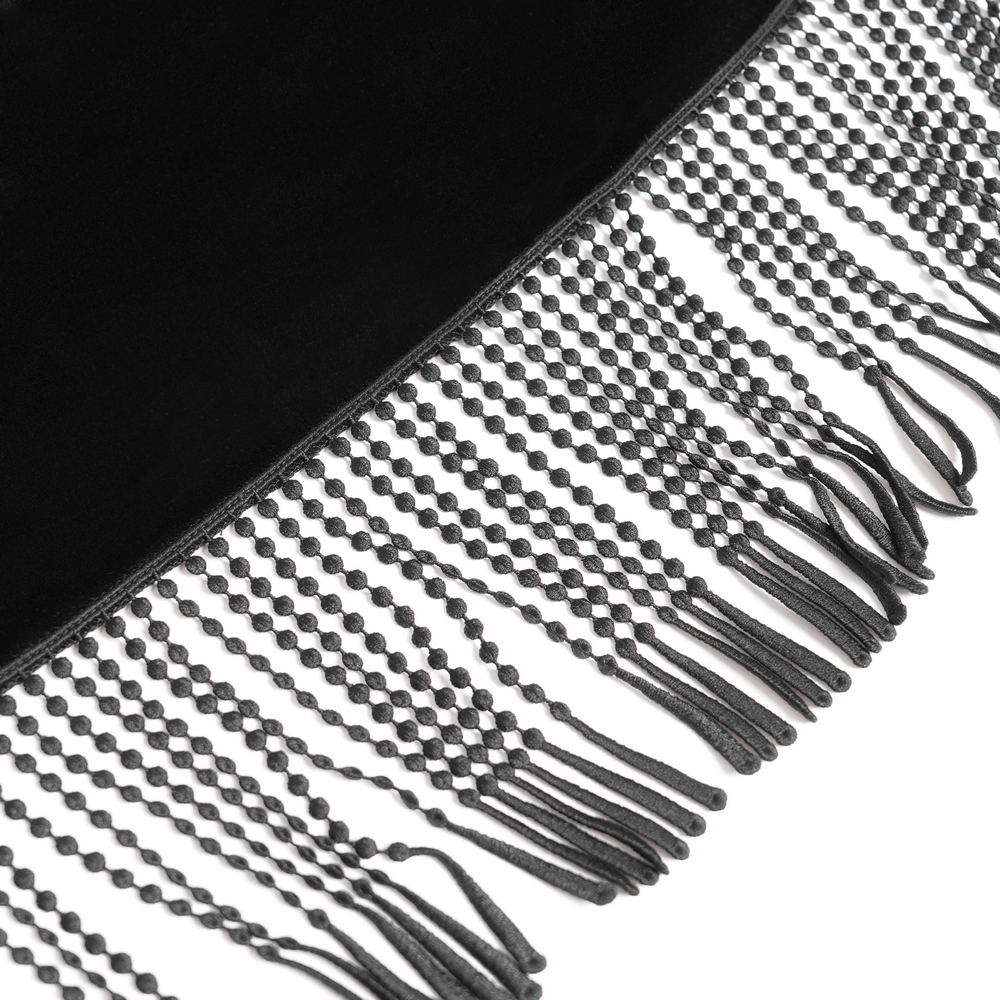 Close-up of black velvet cape fringe detail, showcasing elegant texture and design for gothic-inspired outfits.