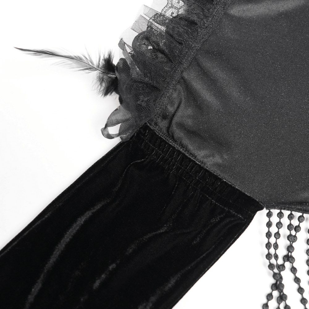 Close-up of gothic black velvet cape showing floral lace trim and fringed detailing, perfect for vintage-inspired outfits.