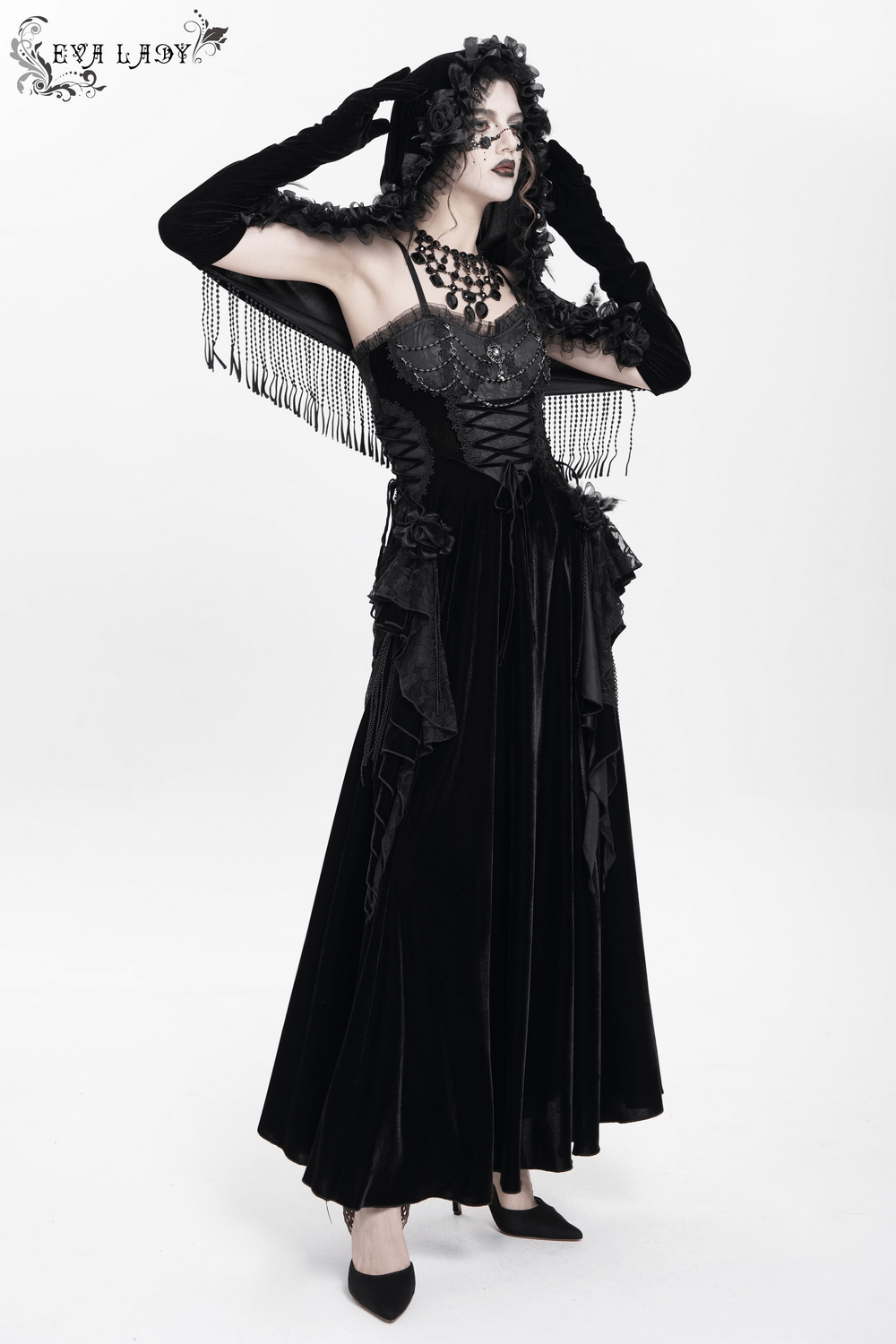 Gothic velvet cape with floral detailing and fringe worn elegantly by a model, perfect for vintage-inspired outfits.