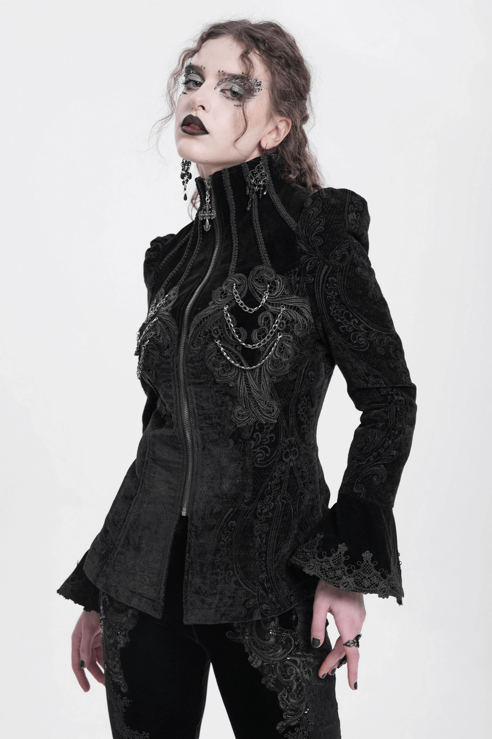 Gothic velvet jacket featuring intricate embroidery and chain details, styled with dramatic bell sleeves.