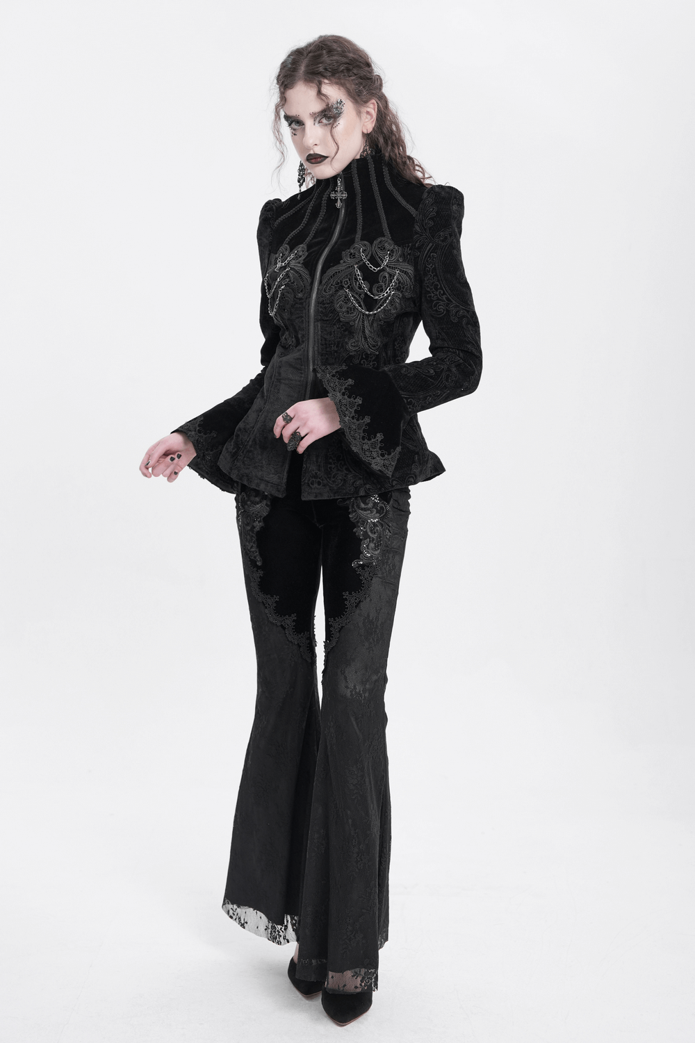 Gothic velvet jacket with embroidery and chain details, paired with sleek flared pants in a stunning Victorian-inspired look.