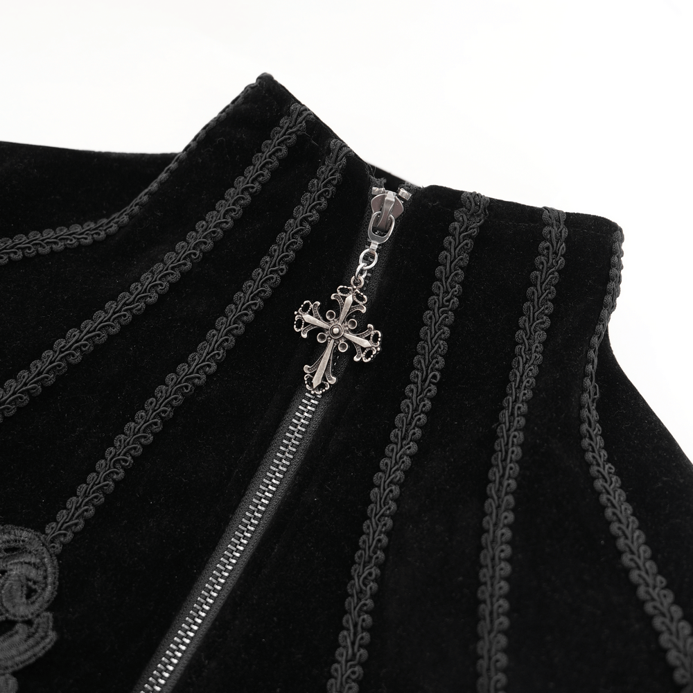 Close-up of gothic velvet jacket zipper with intricate chain cross detail and elegant embroidery.