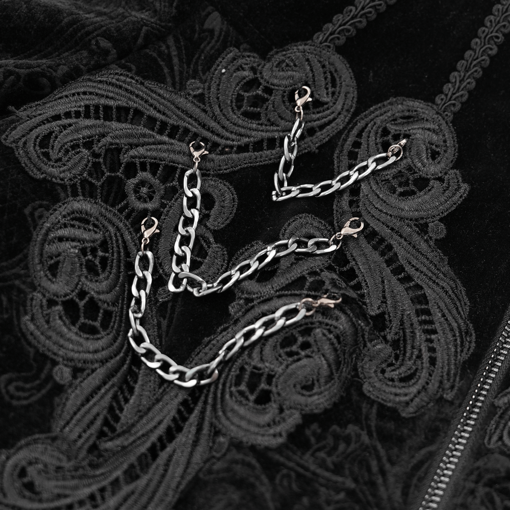 Close-up of black velvet with intricate embroidery and chain details for gothic Victorian jacket.