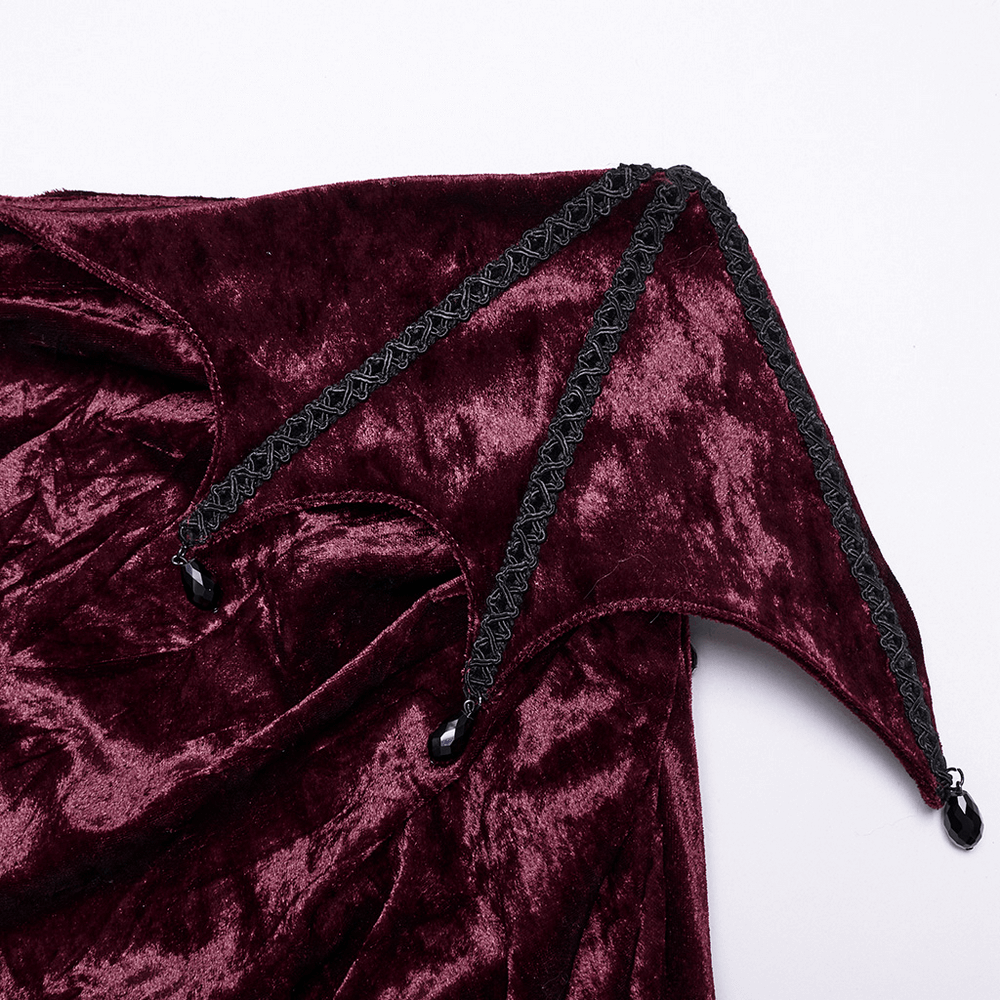 Close-up of burgundy velvet lace detailing with black trim on a gothic asymmetrical skirt