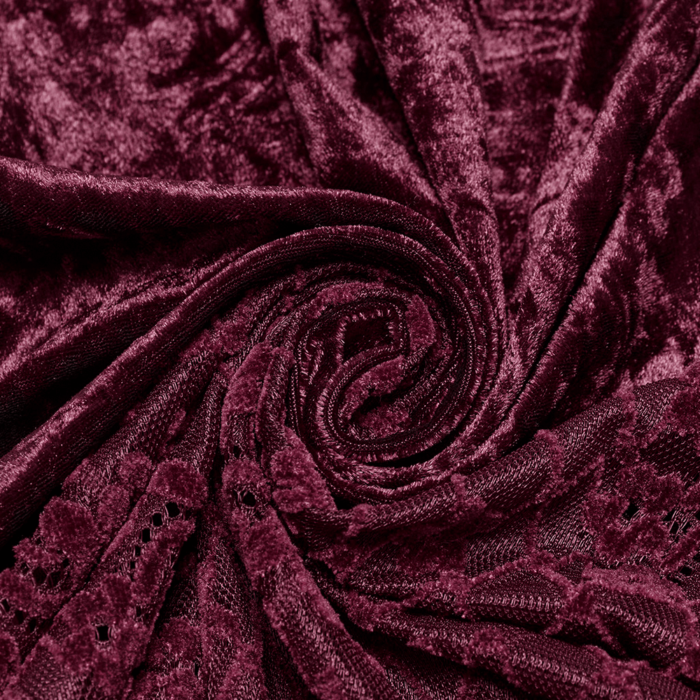 Close-up of rich burgundy velvet fabric with intricate lace detailing, perfect for gothic fashion designs.
