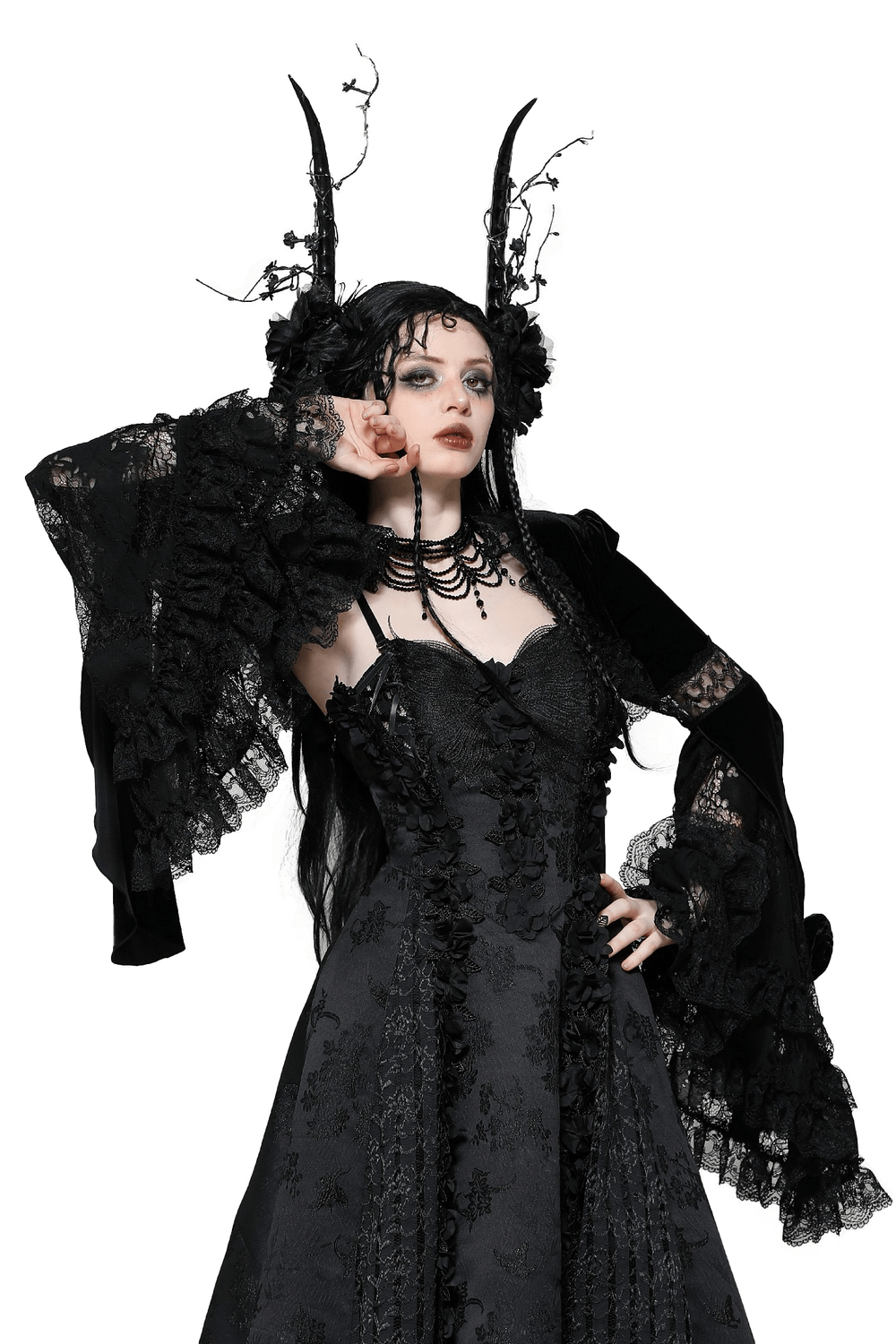 Elegant gothic model in a black lace and velvet bolero, featuring flared sleeves and dramatic accessories.