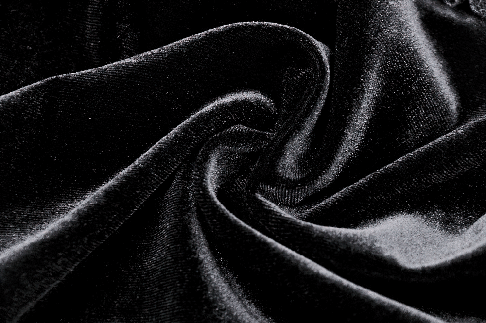 Luxurious black velvet fabric with soft texture, perfect for Gothic fashion and elegant clothing designs.