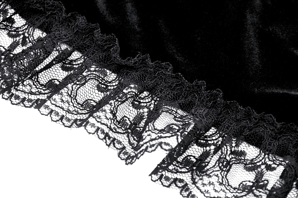 Close-up of black velvet fabric with intricate lace trim, showcasing elegant Gothic style details.