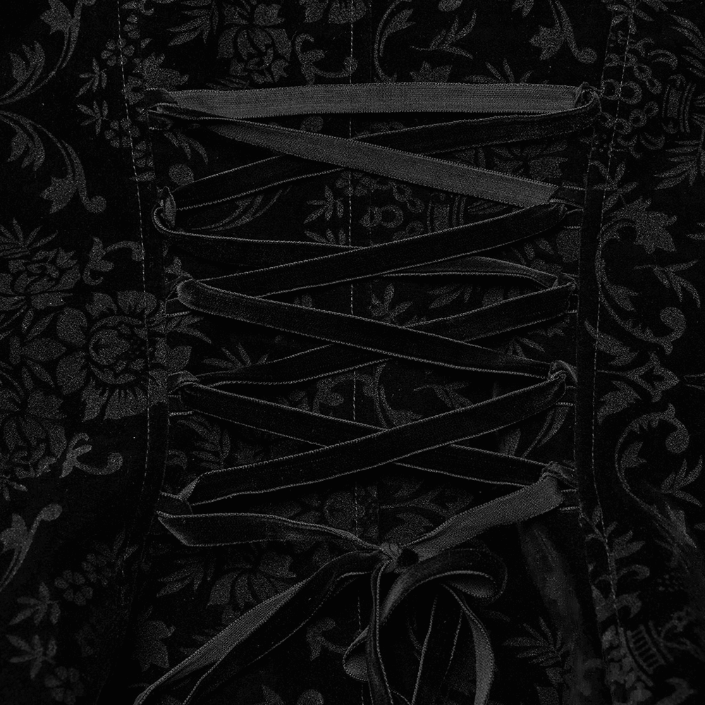 Close-up of black velvet lace-up detailing on Gothic jacket, showcasing intricate floral patterns and elegant ties.
