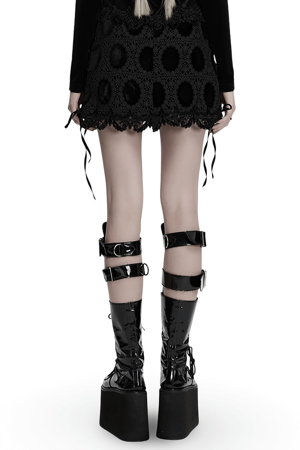 Back view of a model wearing a gothic velvet mini skirt with lace trim and stylish lace-up platform boots.