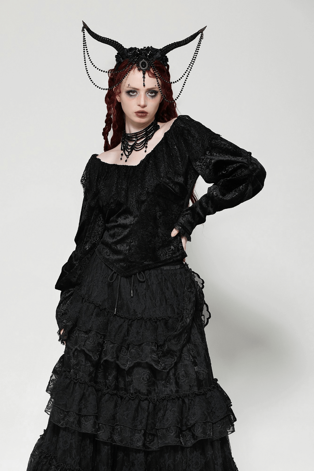 Gothic velvet lace off-shoulder top paired with a dramatic layered skirt and statement accessories, embodying dark elegance.