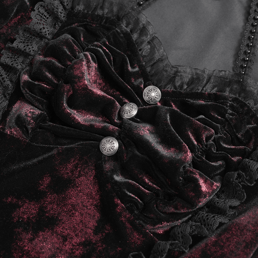 Close-up of gothic velvet top with lace trim and ornate buttons, showcasing Victorian elegance.