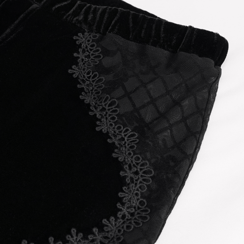 Close-up of gothic velvet flared trousers featuring intricate lace applique and transparent panels.