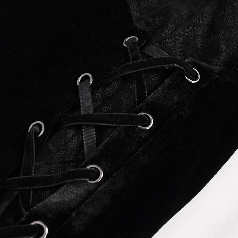 Close-up of black velvet lace-up detail on gothic flared trousers, showcasing elegant craftsmanship and style.