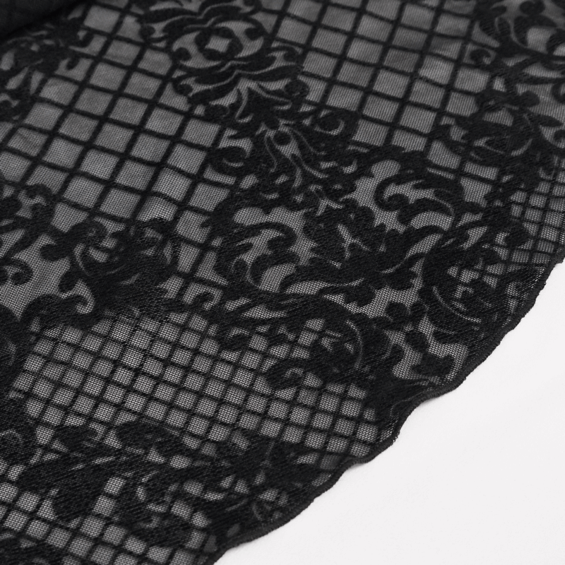 Close-up of intricate black lace fabric featuring a gothic floral design and grid pattern.
